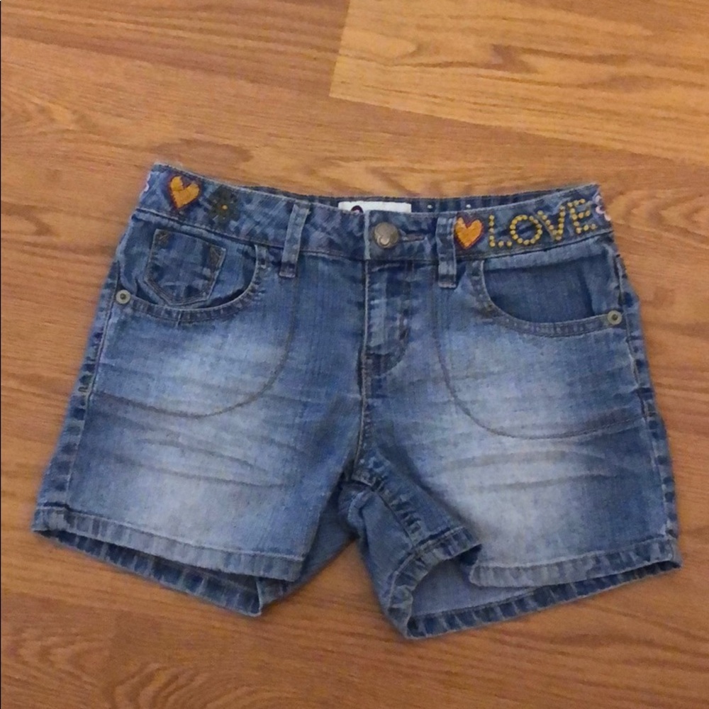 Medium Denim shorts with flower design.